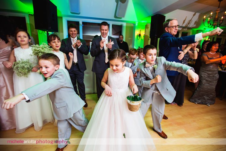 flower girls and ring bearers toss paper shamrocks as brides enter wedding reception