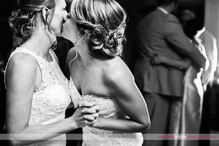 bride kisses bride on the dancefloor during rock island winter wedding reception