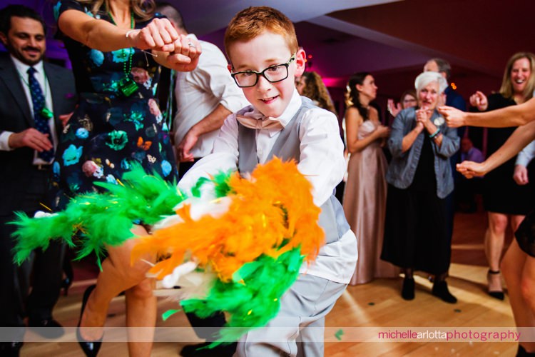 ring bearers owns the dancefloor with boa with Irish flag colors at wedding with dj Paul Knox of sce event group at the rock island lake club in New Jersey