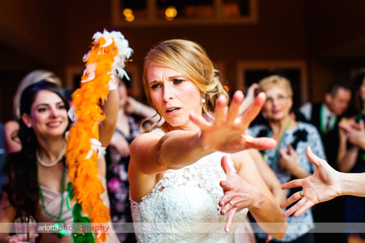 brides tosses boa at camera as she dances during Irish wedding reception