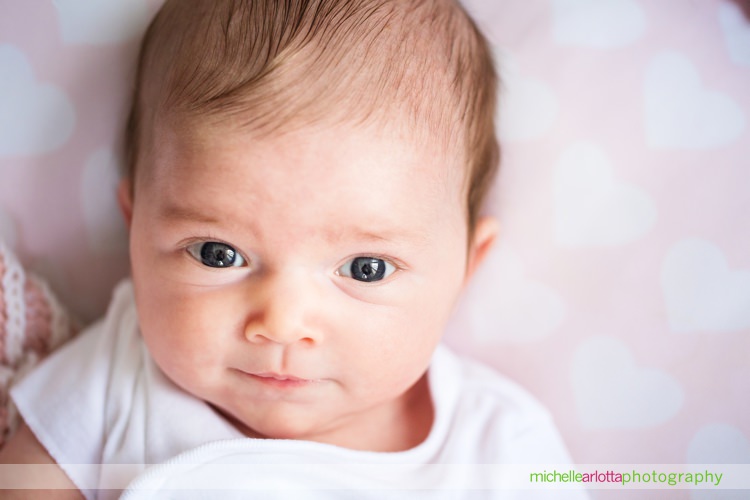 newborn baby girl looking at camera