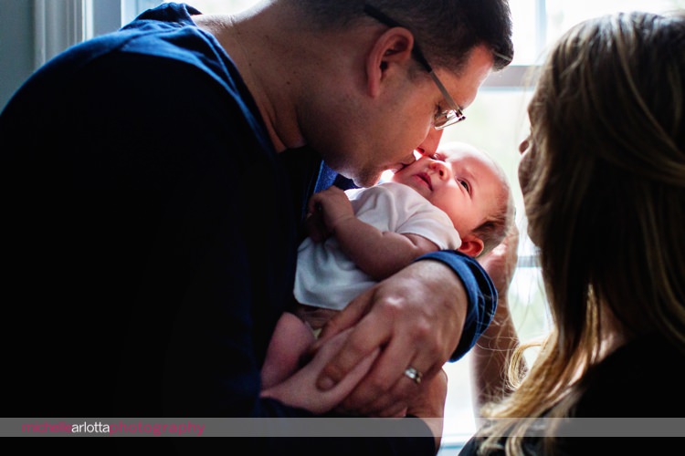 father kisses newborn baby daughter's he'd