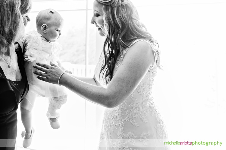 bride reaches out for her baby niece