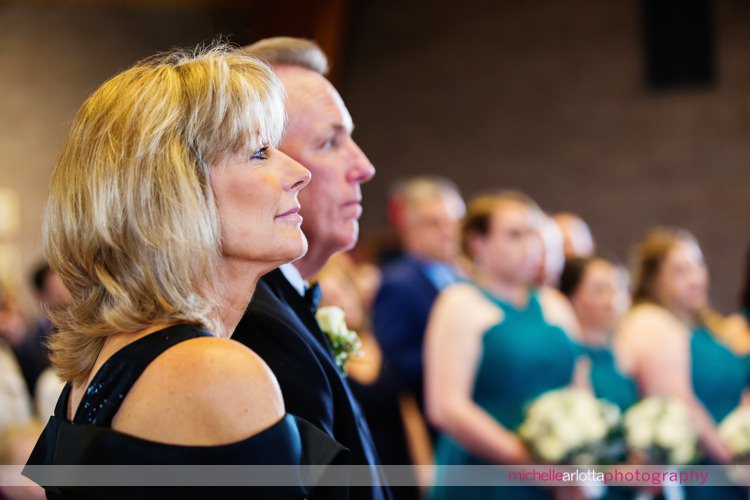 mother of the bride watches wedding ceremony at St Charles Borromeo Church in skillman, NJ