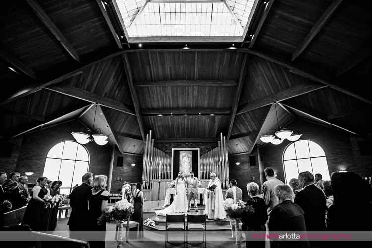 wide angle shot of wedding ceremony at St Charles Borromeo Church in skillman, NJ