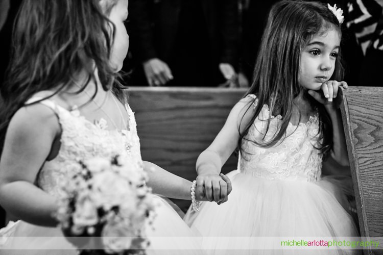 flower girls hold hands during wedding ceremony at St Charles Borromeo Church in skillman, NJ