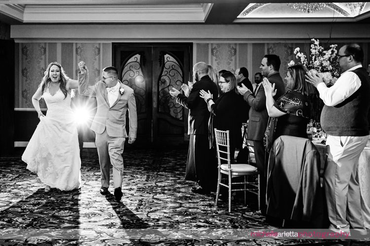 bride and groom enter their reception at grand marquis in old bridge, New Jersey