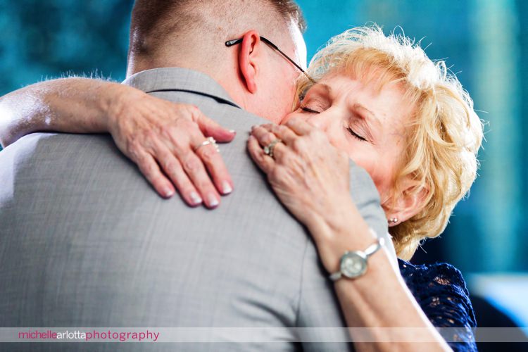 mother hugs her son during mother son dance at New Jersey wedding