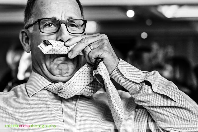 wedding guest uses tie as mustache during grand marquis wedding reception in old bridge, New Jersey