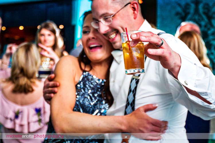 groom holds signature drink and dances at grand marquis in old bridge, NJ