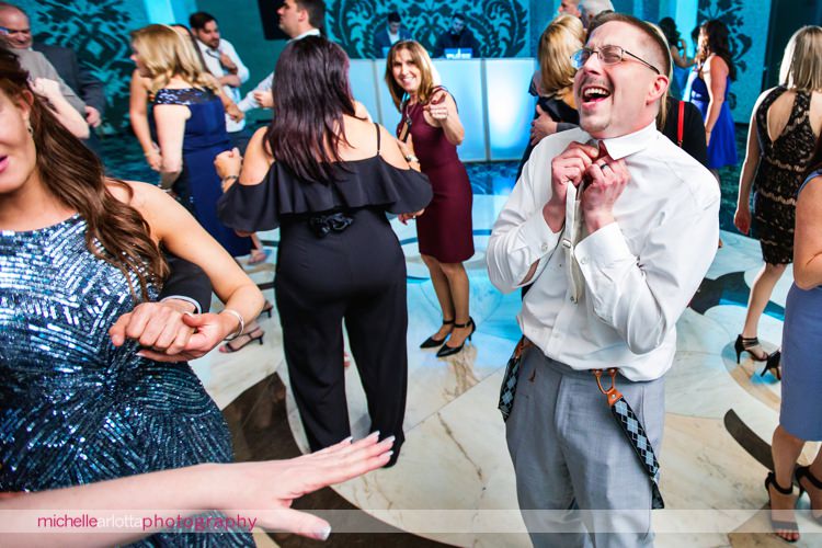 groom takes bowtie off at grand marquis in old bridge, New Jersey