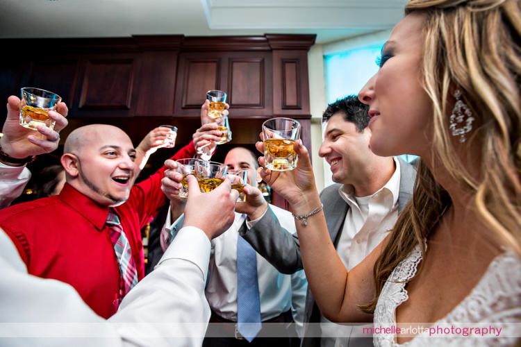 bride and guests do shots together at grand marquis in old bridge, NJ