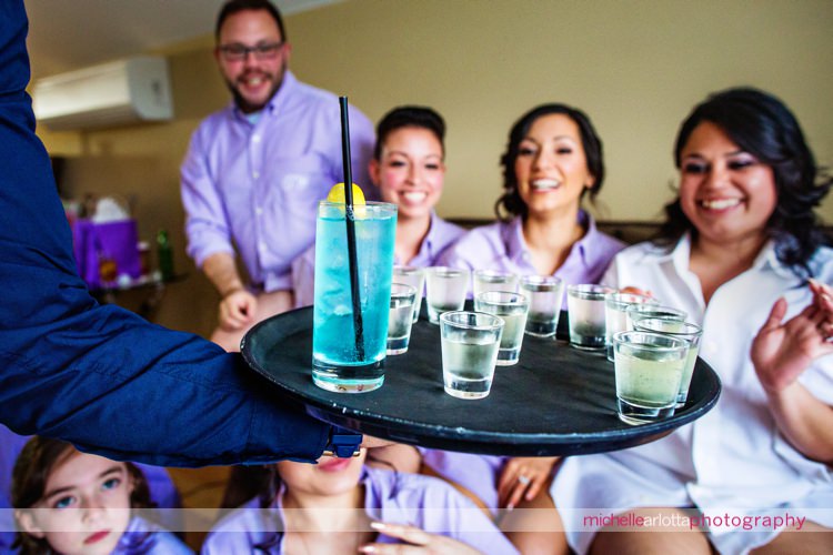 mike delivers shots to bridal party during bride prep at rock island lake club