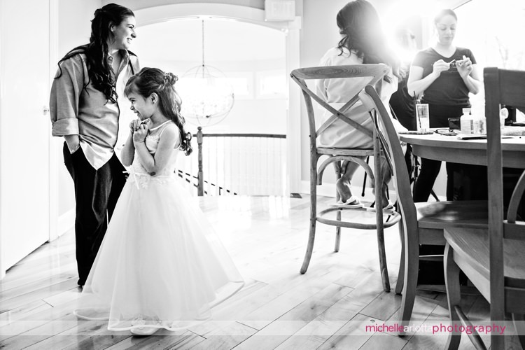 flower girl checks herself out in the mirror for nj wedding