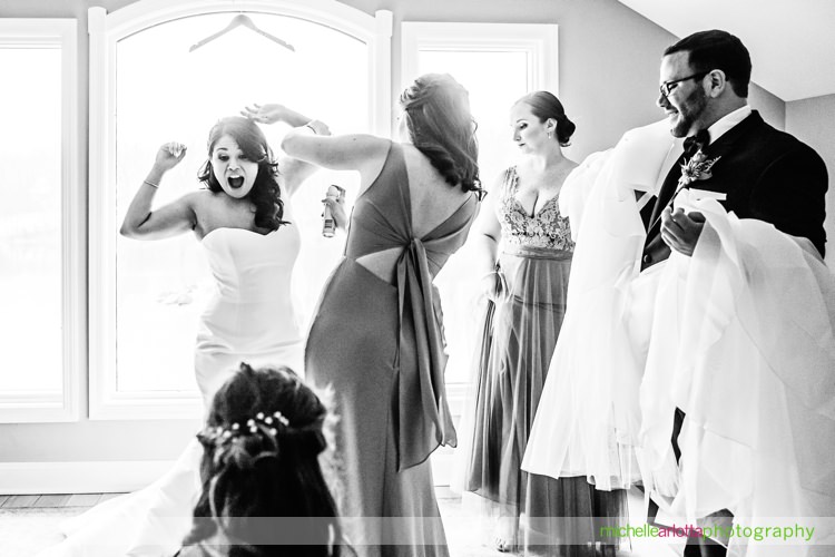 bride makes a face as bridesmaid applies deodorant during rock island lake club wedding