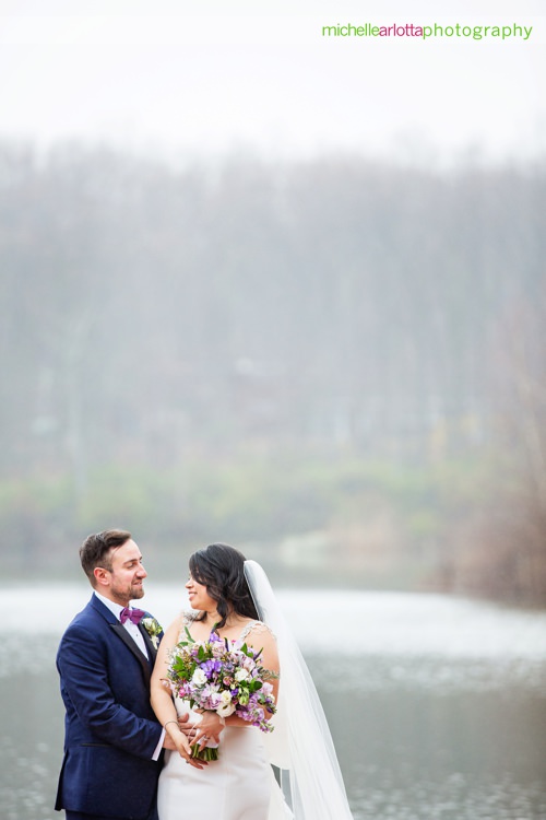 bride and groom on dock at New Jersey wedding venue rock island lake club