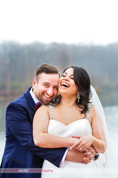groom makes bride laugh during rock island lake club spring wedding portraits