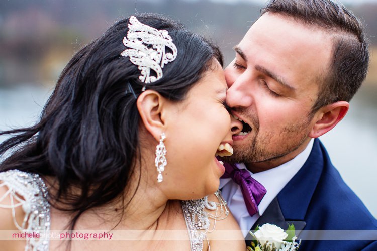 groom jokingly bites bride's nose at New Jersey wedding