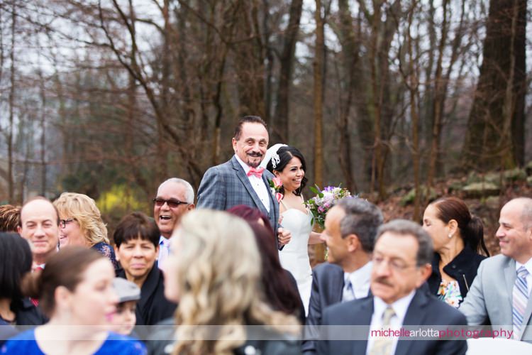 bride and her father walk down the aisle during rock island lake club spring wedding outdoor ceremony