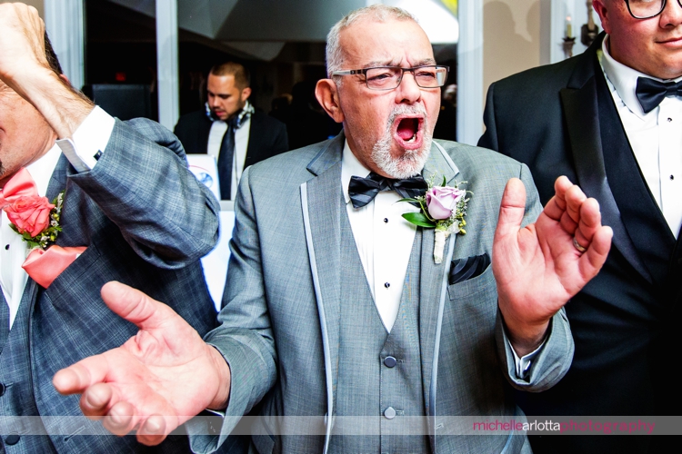 father of the groom cheers as bride and groom enter their Sparta New Jersey wedding reception