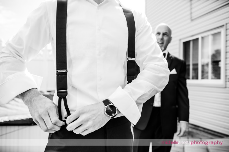 groom puts on suspenders