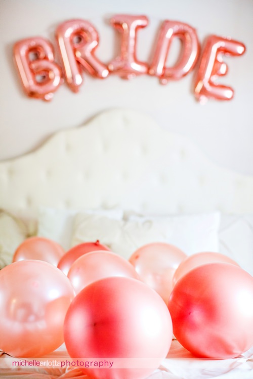 bride spelled out in balloons with pink balloons on bride's bed in Staten Island ny
