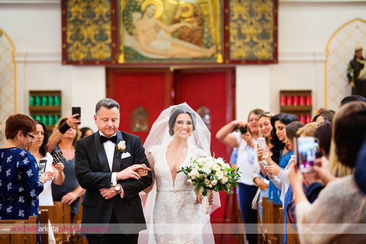 bride and her father walk down the aisle at sacred heart church on staten island