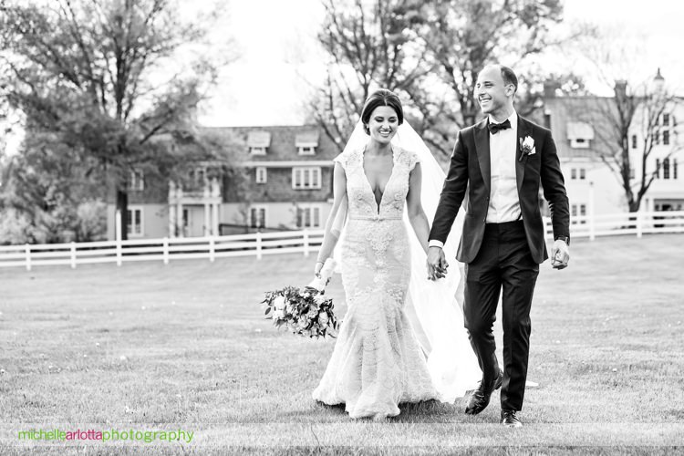 bride wearing berta wedding dress walks with groom at Ryland inn New Jersey wedding