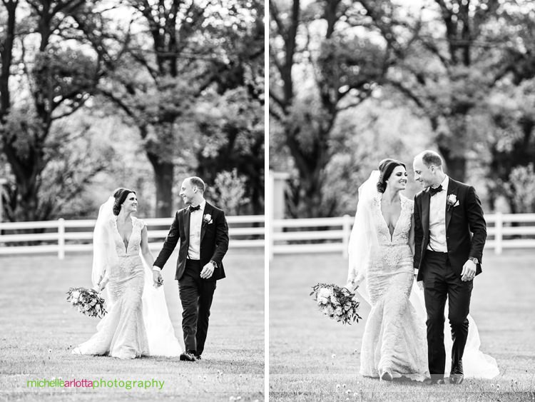 New Jersey wedding photographer Michelle arlotta captures bride in berta wedding gown walking hand in hand with groom at Ryland inn