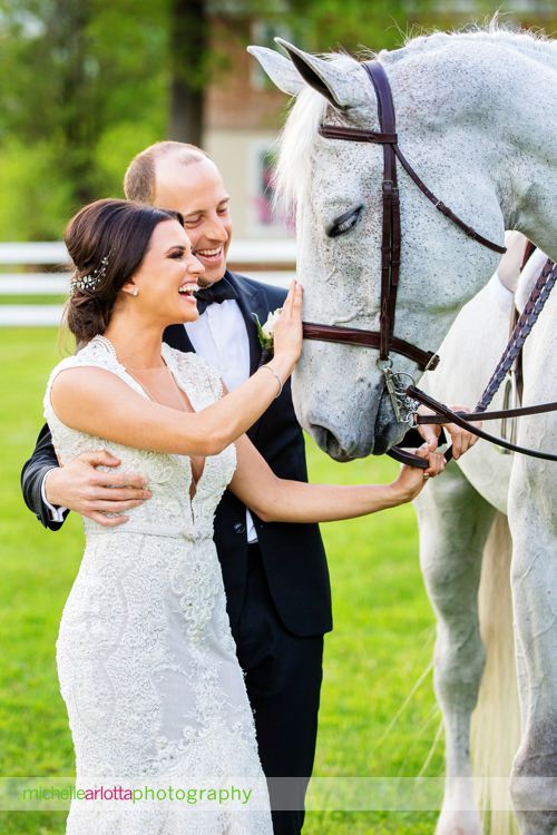bride in berta bridal gown and groom pet horse at modern rustic Ryland inn wedding in New Jersey