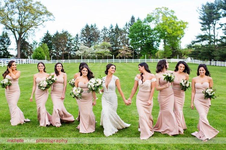 berta bride with bridesmaids in light pink white runway bridesmaid dresses walk together during New Jersey wedding