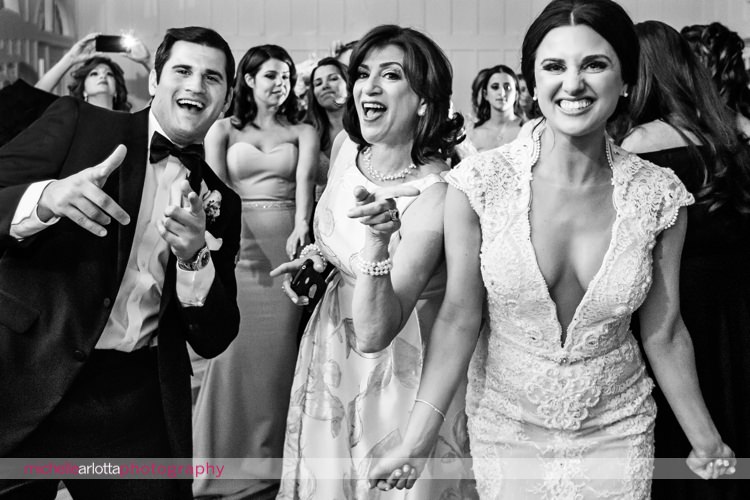 bride in berta wedding down and wedding guests dancing during reception at nj Ryland inn