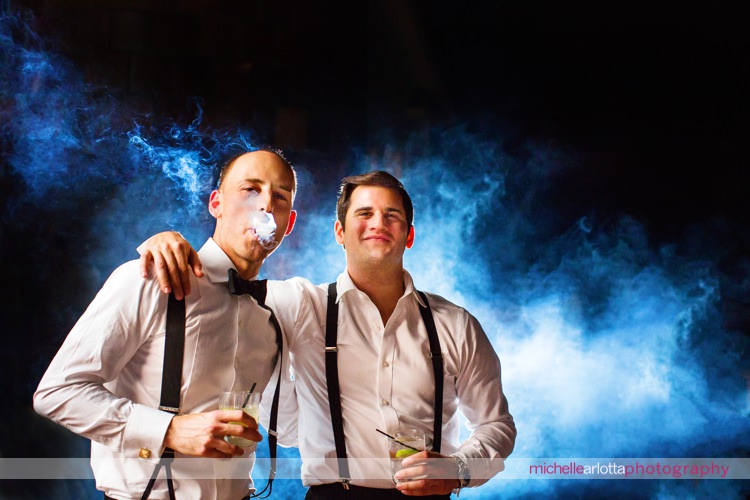 groom and brother in law smoke cigars during nj wedding reception park chateau wedding