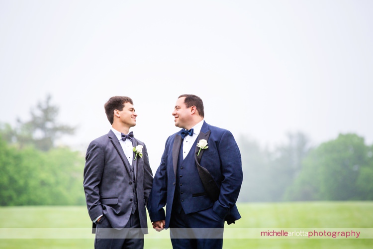two grooms smiling during portraits at New Jersey's rockaway river country club in denville nj