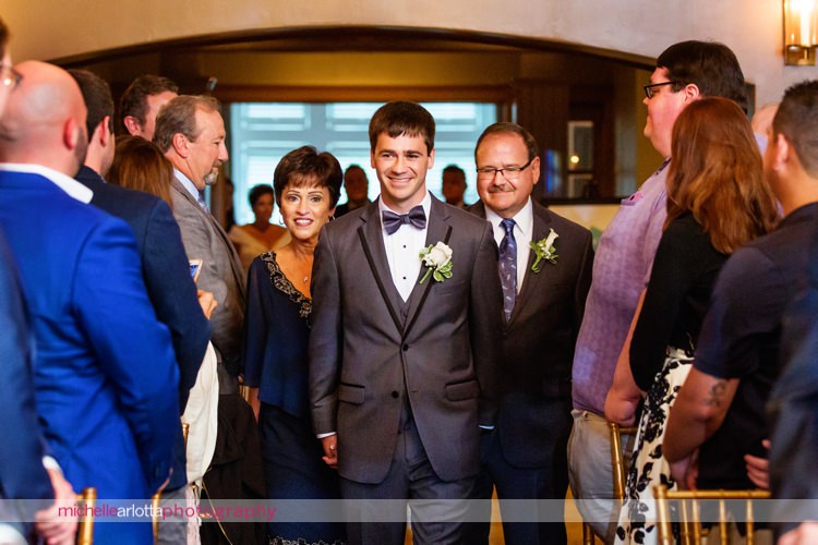 groom walks down aisle with mother and father for nj wedding