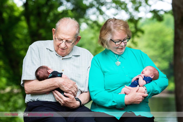 grandparents holding their premie newborn twin granddaughter and grandson
