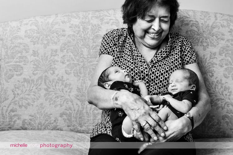 grandmother holds her newborn twin grandson and granddaughter in her arms in New Jersey