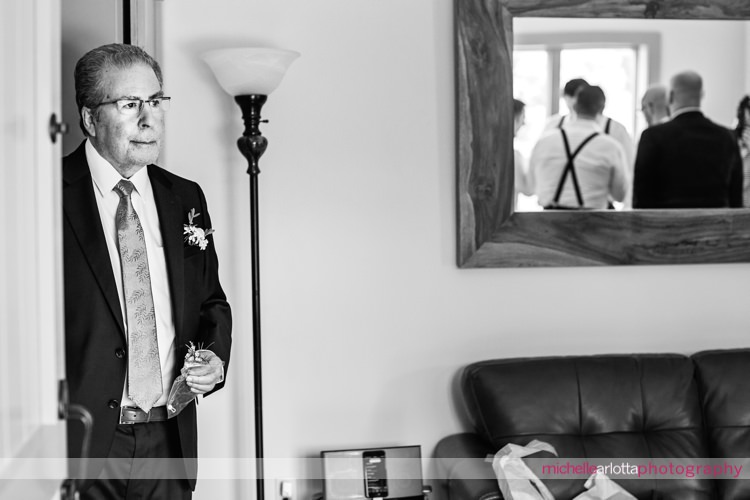 father of the bride watches as groomsmen get ready for Sparta nj wedding