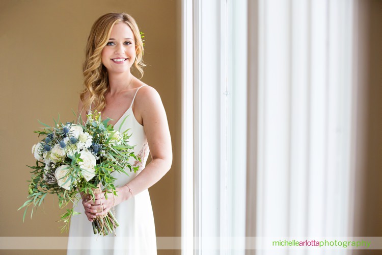 a touch of elegance events bouquet with bride in Sarah seven wedding dress makeup by Samantha linn MUA