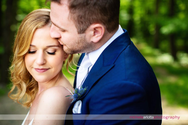 groom in blue suit kisses bride's forehead Sparta New Jersey wedding