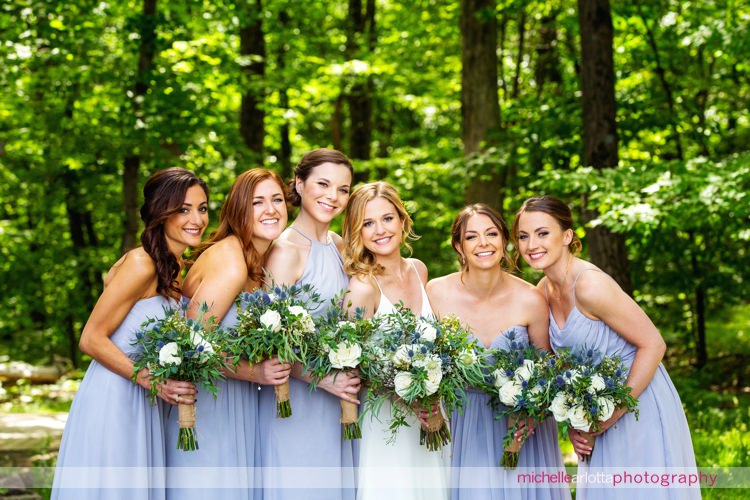 bride wearing Sarah seven wedding dress and bridesmaids wearing weddington way dresses holding botanical bouquets by ATOE events