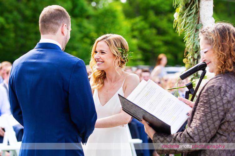 bride laughs during New Jersey wedding ceremony