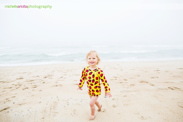 toddler is all smiles during family session at New Jersey shore with Michelle arlotta photography