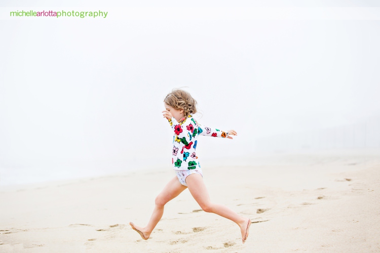 little girl runs to the water during New Jersey beach family photo session