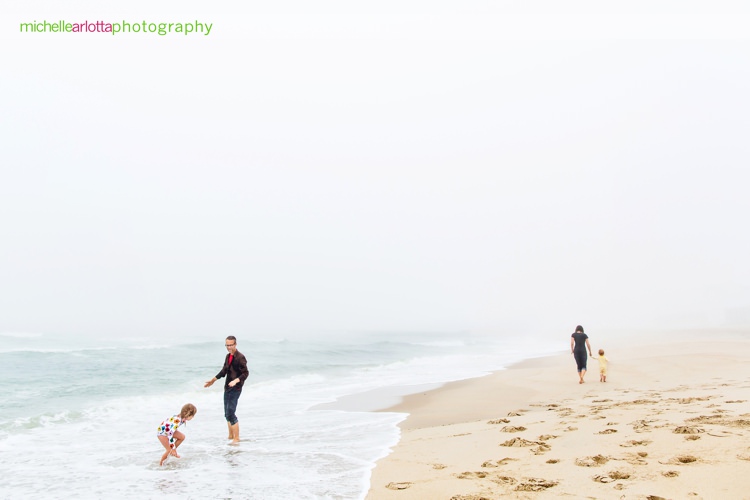 family of four hangs out on a foggy day during new jersey shore candid family photography 