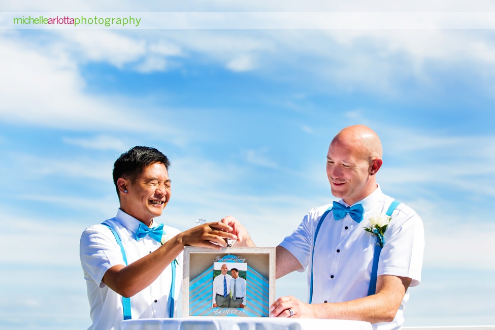 jim and Doug laugh during their sand ceremony at their same sex cape may New Jersey rooftop wedding ceremony