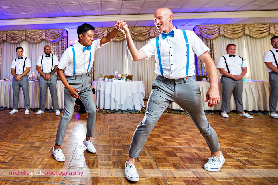 two grooms breakout into a fast dance performance during their first dance at their grand hotel cape may wedding