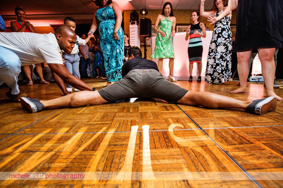 wedding guest does a full split on dancefloor during same sex wedding couple's New Jersey shore grand hotel cape may wedding