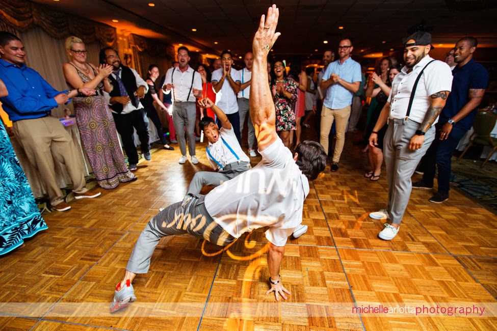 wedding guests breakdancing during same sex wedding couple's New Jersey shore grand hotel cape may wedding with dj bobby lafauci of sce events