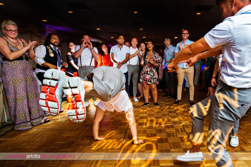 wedding guests breakdancing during same sex wedding couple's New Jersey shore grand hotel cape may wedding with dj bobby lafauci of sce events